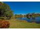 Landscaped backyard with lake view and lush greenery at 7156 Rue De Palisades # 3, Sarasota, FL 34238