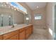 Bathroom with double vanity, bathtub, and large mirror at 7156 Rue De Palisades # 3, Sarasota, FL 34238