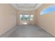 Bright bedroom with bay window, ceiling fan, and carpeting at 7156 Rue De Palisades # 3, Sarasota, FL 34238