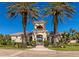 Elegant community entrance with palm trees and gated entry at 7156 Rue De Palisades # 3, Sarasota, FL 34238