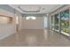 Bright dining room with tile floors, coffered ceiling, and sliding glass doors leading to the outdoors at 7156 Rue De Palisades # 3, Sarasota, FL 34238