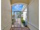Enclosed entryway with ornate gate and view of the courtyard and landscaping at 7156 Rue De Palisades # 3, Sarasota, FL 34238
