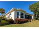 Back of house showcases corner windows, landscaping, and a view of the lake at 7156 Rue De Palisades # 3, Sarasota, FL 34238