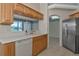 View of kitchen with stainless steel refrigerator and ample cabinetry at 7156 Rue De Palisades # 3, Sarasota, FL 34238