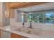 Kitchen sink with view of a tranquil lake from window at 7156 Rue De Palisades # 3, Sarasota, FL 34238