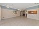 Open living room with tile floor and kitchen pass-through at 7156 Rue De Palisades # 3, Sarasota, FL 34238