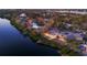 Aerial view of a waterfront home with a dock and pool at sunset at 7618 Midnight Pass Rd, Sarasota, FL 34242