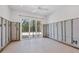 Spacious bedroom mid-renovation with sliding glass doors and tiled flooring at 7618 Midnight Pass Rd, Sarasota, FL 34242