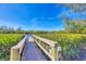 Private dock extending into the water surrounded by greenery at 7618 Midnight Pass Rd, Sarasota, FL 34242