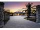 Brick paver driveway with open gates at sunset at 7618 Midnight Pass Rd, Sarasota, FL 34242