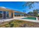 Backyard with pool, sliding glass doors, and windows at 7618 Midnight Pass Rd, Sarasota, FL 34242