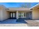 Front exterior of a home with double door entry and sliding glass windows at 7618 Midnight Pass Rd, Sarasota, FL 34242