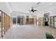 Large, open living room undergoing renovations with tiled flooring and ceiling fan at 7618 Midnight Pass Rd, Sarasota, FL 34242