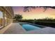 Tranquil pool with paver patio and sunset views over the waterway at 7618 Midnight Pass Rd, Sarasota, FL 34242