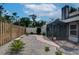 Landscaped backyard featuring a screened in enclosure and a paver path at 7806 Ontario Street Cir # 7806, Sarasota, FL 34243