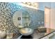 Stylish bathroom featuring a unique vessel sink, decorative tile backsplash, and modern lighting at 7806 Ontario Street Cir # 7806, Sarasota, FL 34243