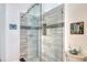 Modern bathroom showcasing a glass-enclosed shower with decorative tile accents at 7806 Ontario Street Cir # 7806, Sarasota, FL 34243