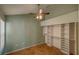 Bedroom featuring a ceiling fan, an open closet with shelving and tile flooring at 7806 Ontario Street Cir # 7806, Sarasota, FL 34243