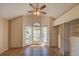 Bright bedroom featuring a large window, vaulted ceilings, tile floors, and built-in shelving at 7806 Ontario Street Cir # 7806, Sarasota, FL 34243
