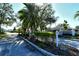 Community entrance featuring lush landscaping and a welcoming sign at 7806 Ontario Street Cir # 7806, Sarasota, FL 34243
