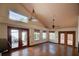 Bright living room with tile flooring, high ceilings, large windows, and French doors leading to the outside at 7806 Ontario Street Cir # 7806, Sarasota, FL 34243