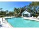 Community pool and pavilion with ample seating and lush surroundings at 7806 Ontario Street Cir # 7806, Sarasota, FL 34243