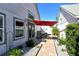 Landscaped backyard with patio and grill area at 7806 Ontario Street Cir # 7806, Sarasota, FL 34243