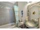 Bathroom with tiled shower, vessel sink, and decorative accents at 7806 Ontario Street Cir # 7806, Sarasota, FL 34243