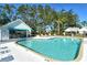 Sparkling community pool with a pool house and plenty of lounge chairs at 7806 Ontario Street Cir # 7806, Sarasota, FL 34243