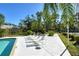 Relaxing community pool area with lounge chairs and lush landscaping at 7806 Ontario Street Cir # 7806, Sarasota, FL 34243