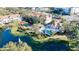 Aerial view of community with pool, tennis court and pond at 850 S Tamiami Trl # 402, Sarasota, FL 34236