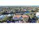 Aerial view of waterfront community with tennis court and pool at 850 S Tamiami Trl # 402, Sarasota, FL 34236