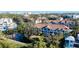 Aerial view of a community near a pond, showcasing multiple buildings at 850 S Tamiami Trl # 402, Sarasota, FL 34236