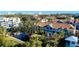 Aerial view of the community, showcasing landscaping and pond at 850 S Tamiami Trl # 402, Sarasota, FL 34236