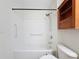 Clean bathroom with a shower/tub combo and wood cabinet at 850 S Tamiami Trl # 402, Sarasota, FL 34236