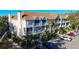 Two-story building exterior with ample parking and lush landscaping at 850 S Tamiami Trl # 402, Sarasota, FL 34236