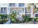 Building 4 exterior featuring multi-story building with balconies and tropical landscaping at 850 S Tamiami Trl # 402, Sarasota, FL 34236