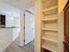 Hallway with a large pantry and view into the kitchen at 850 S Tamiami Trl # 402, Sarasota, FL 34236