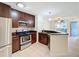 Modern kitchen with dark wood cabinets, stainless steel appliances, and granite countertops at 850 S Tamiami Trl # 402, Sarasota, FL 34236