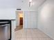 Kitchen with white walls, tile floors, and stainless steel appliances at 850 S Tamiami Trl # 402, Sarasota, FL 34236