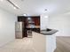 Modern kitchen with dark wood cabinets and granite countertops at 850 S Tamiami Trl # 402, Sarasota, FL 34236
