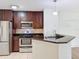 Modern kitchen with stainless steel appliances and granite countertops at 850 S Tamiami Trl # 402, Sarasota, FL 34236