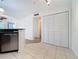 Kitchen with stainless steel dishwasher and laundry closet at 850 S Tamiami Trl # 402, Sarasota, FL 34236