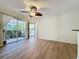 Living room with patio access, ceiling fan, and neutral color scheme at 850 S Tamiami Trl # 402, Sarasota, FL 34236