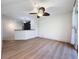 Bright living room with light wood flooring, ceiling fan, and access to patio at 850 S Tamiami Trl # 402, Sarasota, FL 34236