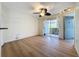Spacious living area with wood-look floors, sliding door to patio, and ceiling fan at 850 S Tamiami Trl # 402, Sarasota, FL 34236