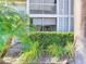Screened-in patio with lush landscaping and building view at 850 S Tamiami Trl # 402, Sarasota, FL 34236