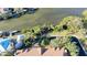 Aerial view of waterfront property with lush vegetation and private dock at 850 S Tamiami Trl # 402, Sarasota, FL 34236