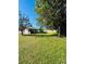 View of the home's backyard, featuring a large grassy area at 865 Beverly Rd, Venice, FL 34293