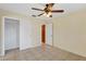 A spacious bedroom with tile floors, a ceiling fan, and closet at 865 Beverly Rd, Venice, FL 34293